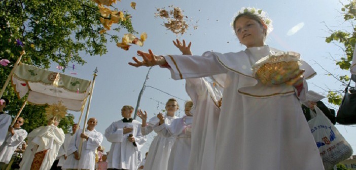 Girls throw flower petals during a procession celebrating the on the feast of the Body and Blood of Christ in Minsk, Belarus, May 29. (CNS photo/Vladimir Nikolsky, Reuters) (May 31, 2011)